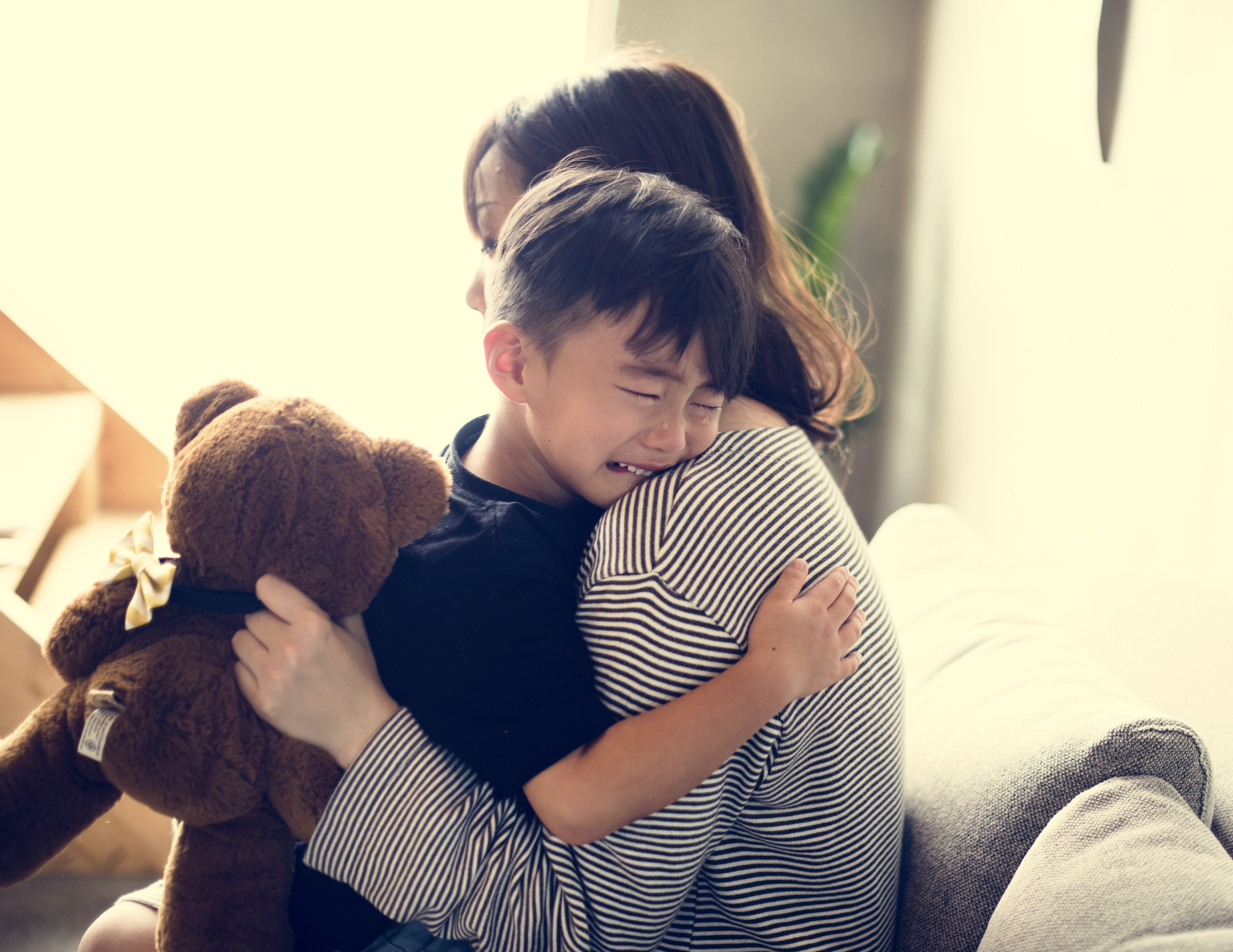 Boy crying near mother