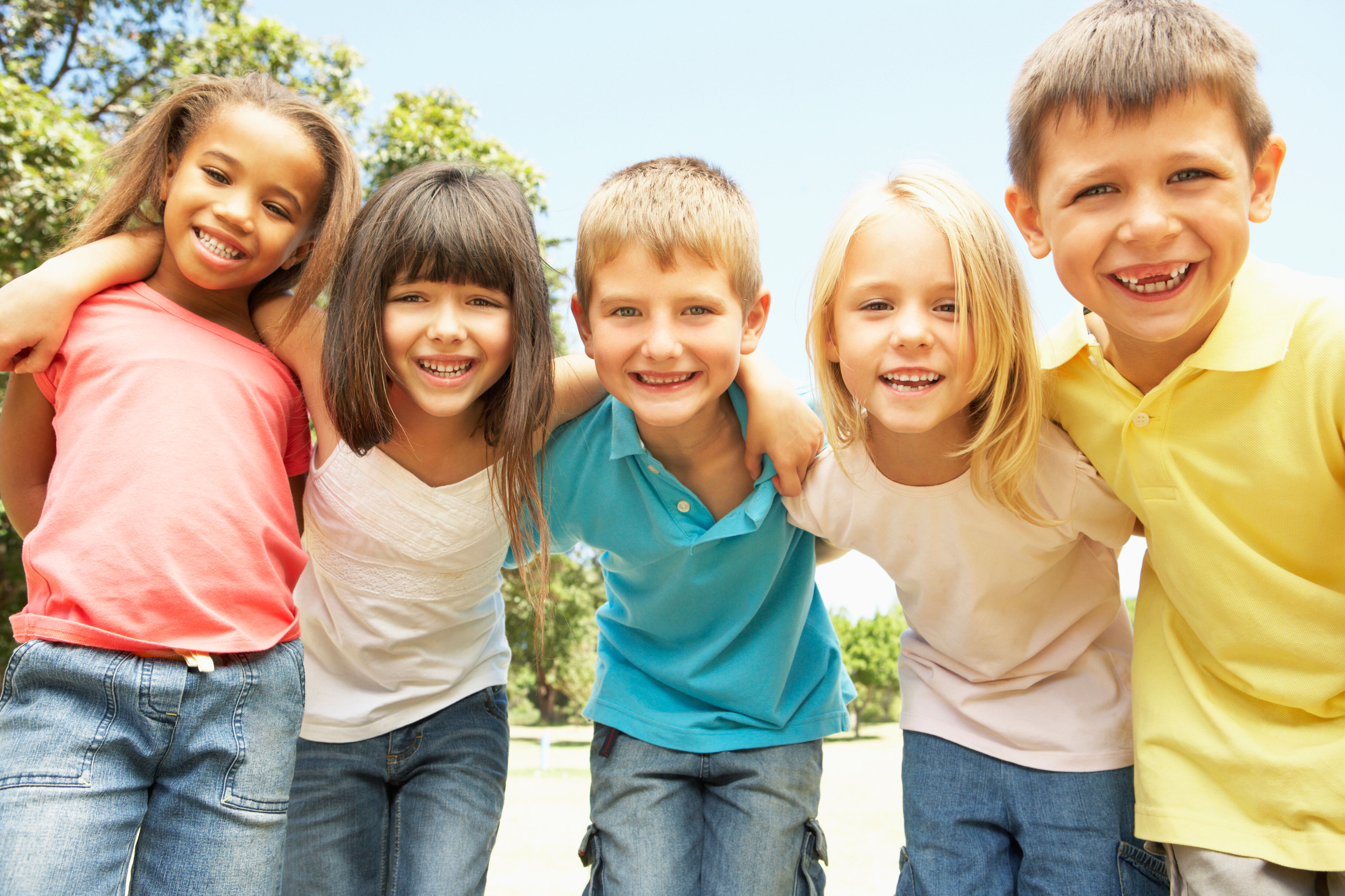 Children look at the camera and smile