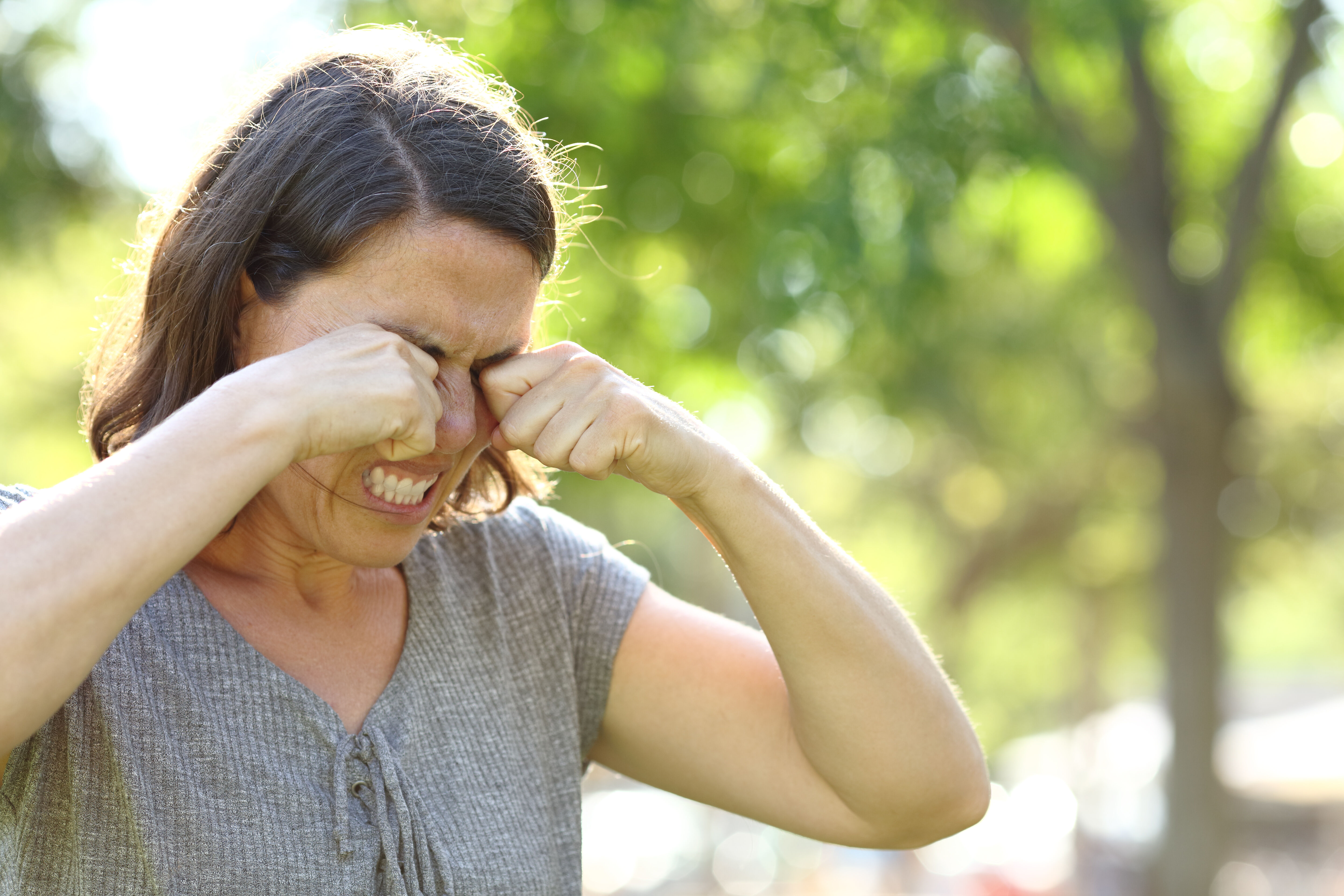 Woman rubs her eyes