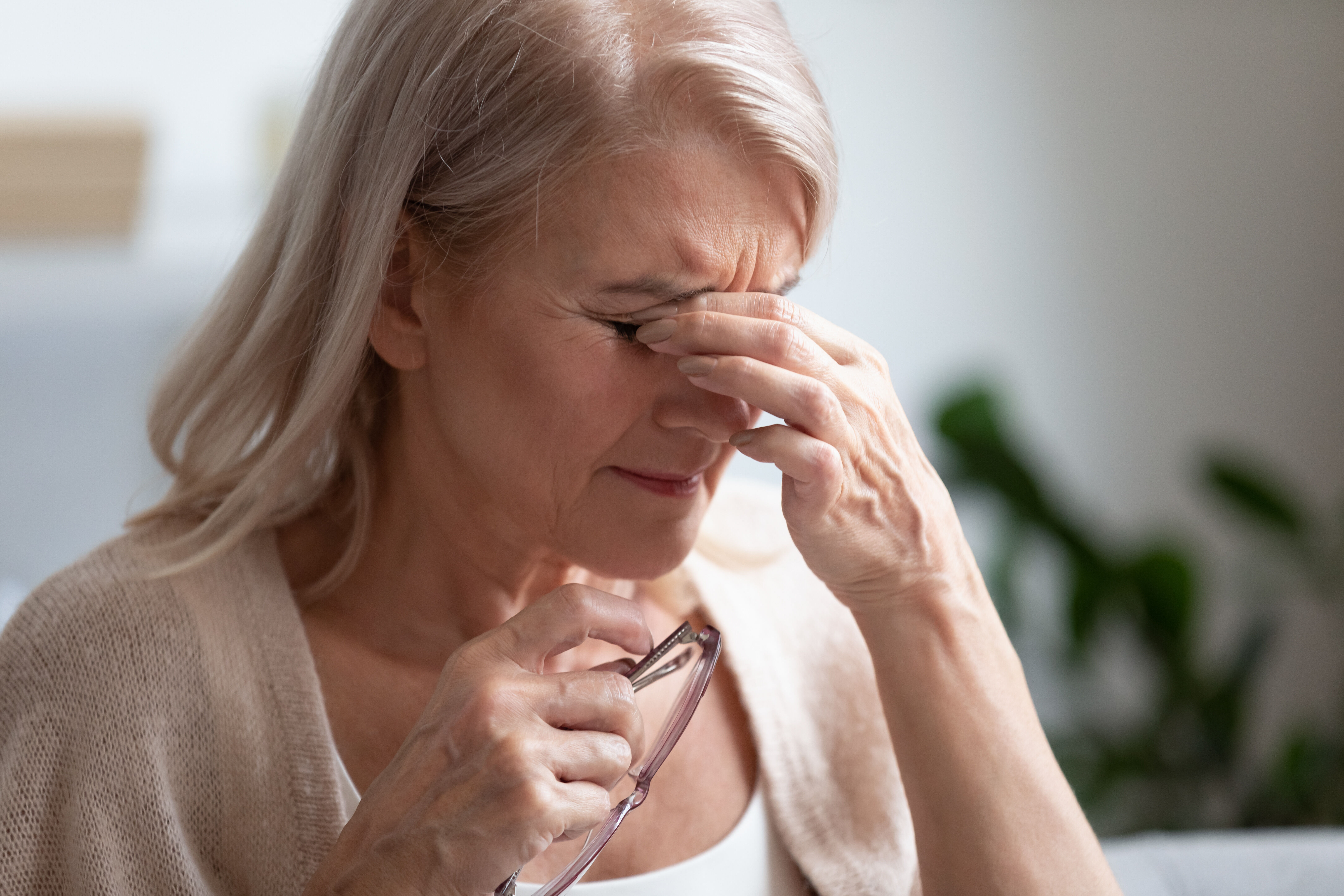 Woman rubs tired eyes