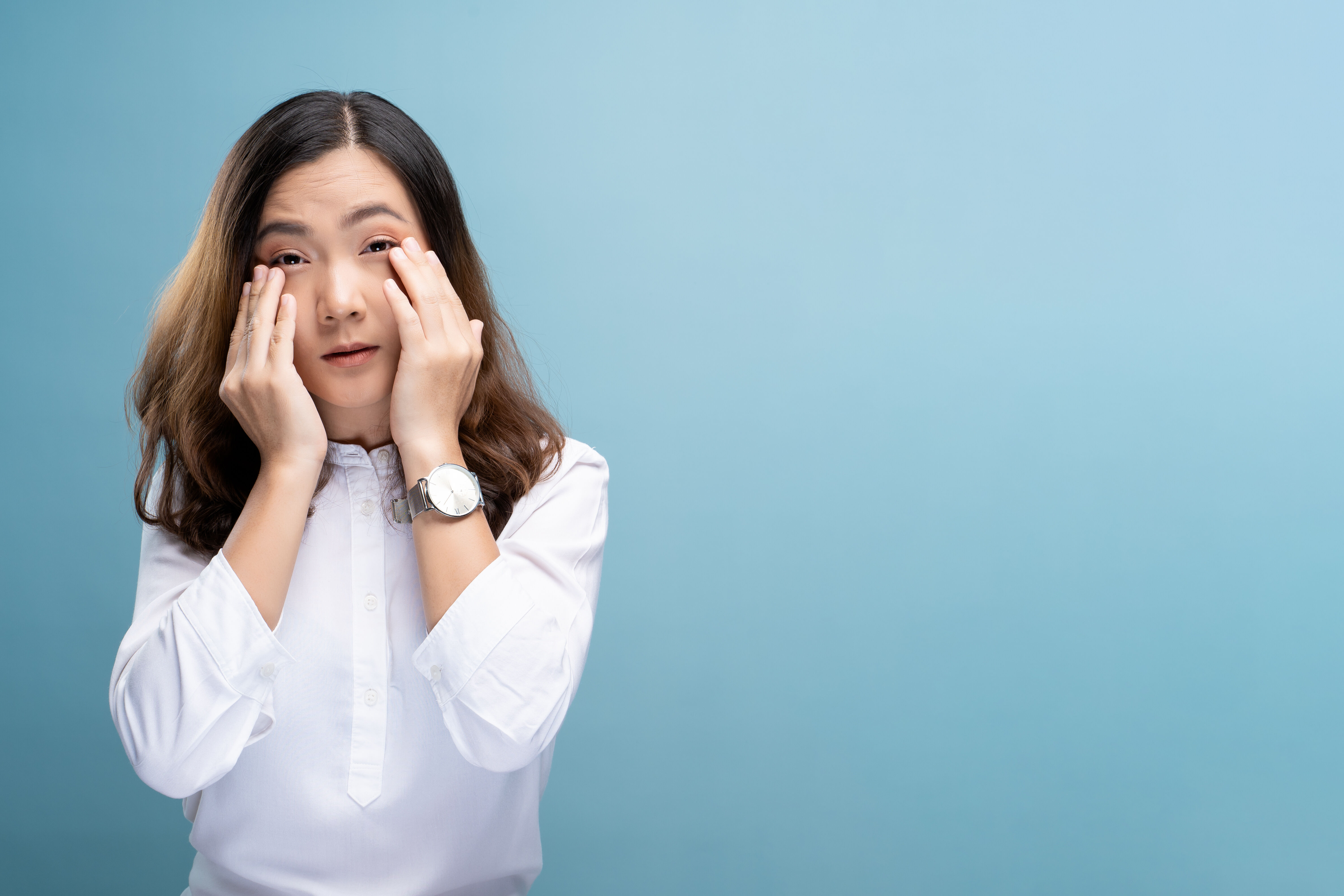 Woman rubs her eyes